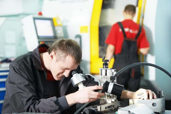 Skilled technical staff examining parts